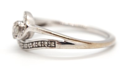 Lot 17 - A 9ct diamond ring, set to centre with four...