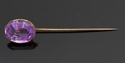 Lot 332 - An amethyst stick pin, the oval mixed cut...