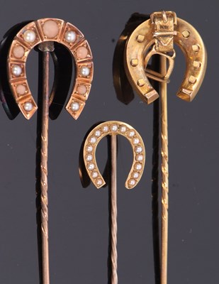 Lot 334 - Three cased horseshoe stick pins, the first a...