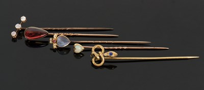 Lot 335 - Five gemset stick pins, to include an unmarked...