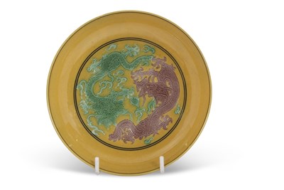 Lot 139 - A yellow ground saucer painted with opposing...
