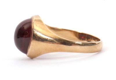 Lot 48 - A 9ct garnet ring, the oval garnet cabochon in...