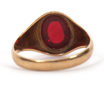 Lot 48 - A 9ct garnet ring, the oval garnet cabochon in...