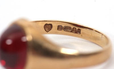 Lot 48 - A 9ct garnet ring, the oval garnet cabochon in...