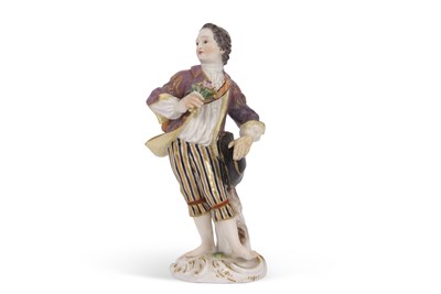 Lot 15 - A Meissen figure of a gallant holding a posie...