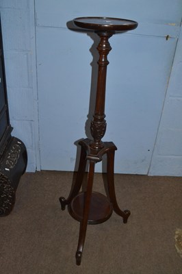 Lot 515 - An early 20th Century mahogany torchere plant...