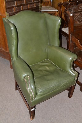 Lot 543 - Georgian style green leather upholstered wing...