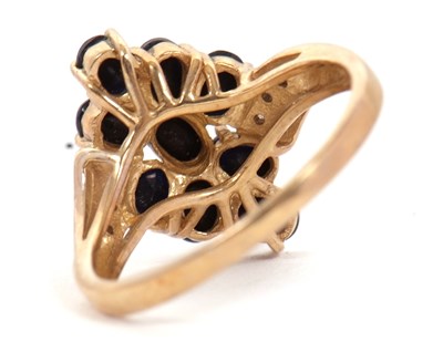 Lot 90 - A 9ct sapphire and diamond cluster ring, with...