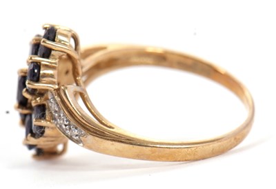 Lot 90 - A 9ct sapphire and diamond cluster ring, with...
