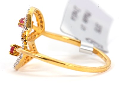 Lot 89 - A 9ct ruby and diamond ring, the two crossover...