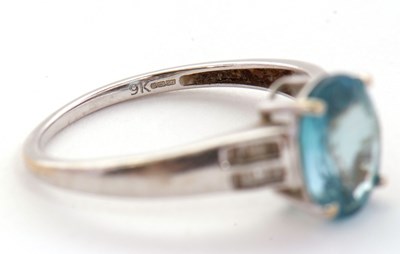 Lot 93 - A 9ct white gold topaz and diamond ring, the...