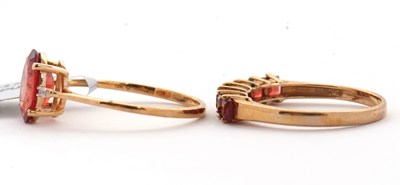 Lot 99 - Two 9ct treated orange quartz rings: to...