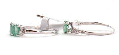 Lot 97 - Two 9ct white gold and emerald rings: the...