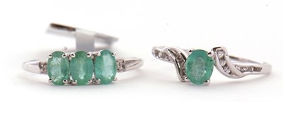 Lot 97 - Two 9ct white gold and emerald rings: the...