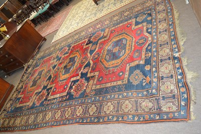 Lot 579 - A large Middle Eastern wool floor rug with...