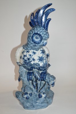 Lot 254 - A large pottery model of a parrot on branch,...