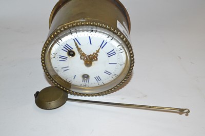 Lot 398 - A brass clock with pendulum