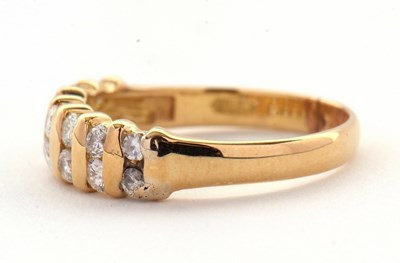 Lot 72 - A diamond ring, the upper half set with small...