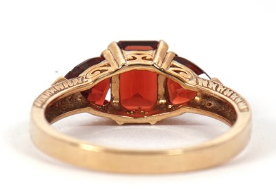 Lot 76 - A 9ct garnet ring, set with a step cut garnet...