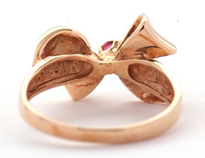 Lot 74 - A 14ct ruby and diamond bow ring, the bow set...