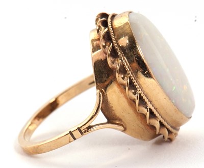 Lot 19 - A 9ct opal ring, the oval opal cabochon,...