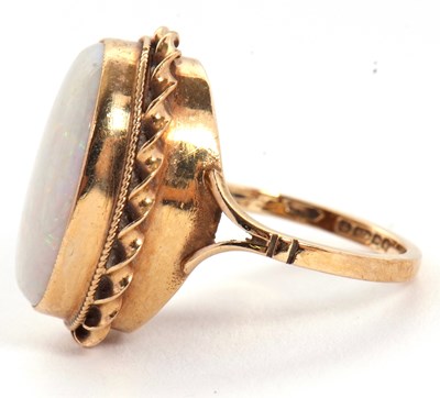 Lot 19 - A 9ct opal ring, the oval opal cabochon,...
