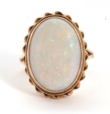 Lot 19 - A 9ct opal ring, the oval opal cabochon,...