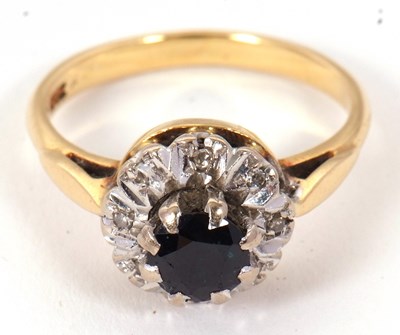 Lot 65 - A sapphire and diamond cluster ring, the...