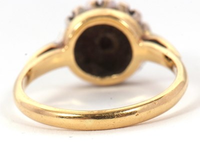 Lot 65 - A sapphire and diamond cluster ring, the...