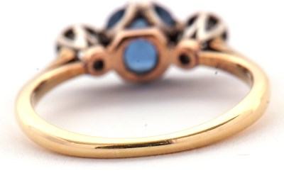 Lot 4 - A sapphire and diamond ring, the central pale...
