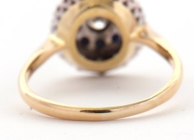 Lot 33 - A sapphire and diamond cluster ring, the...