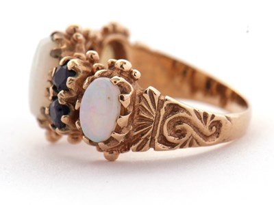 Lot 31 - An opal and sapphire ring, the three slightly...