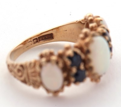 Lot 31 - An opal and sapphire ring, the three slightly...