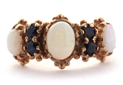 Lot 31 - An opal and sapphire ring, the three slightly...