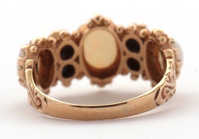 Lot 31 - An opal and sapphire ring, the three slightly...