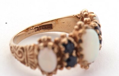 Lot 31 - An opal and sapphire ring, the three slightly...