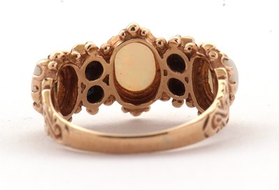 Lot 31 - An opal and sapphire ring, the three slightly...
