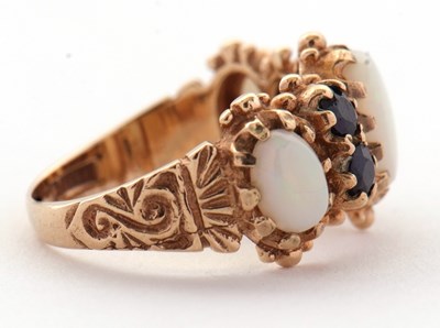 Lot 31 - An opal and sapphire ring, the three slightly...