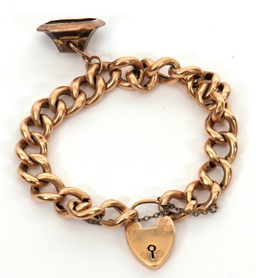Lot 273 - A 15ct curblink bracelet and citrine fob, the...