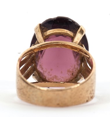 Lot 37 - A gemset ring, the oval purple faceted stone...