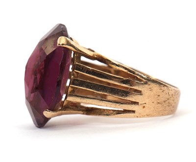 Lot 37 - A gemset ring, the oval purple faceted stone...