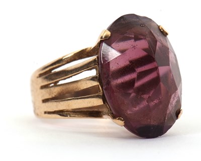 Lot 37 - A gemset ring, the oval purple faceted stone...