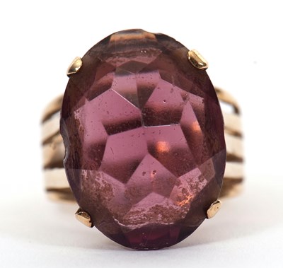Lot 37 - A gemset ring, the oval purple faceted stone...