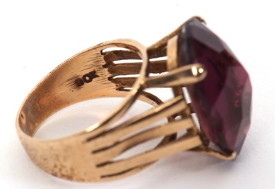 Lot 37 - A gemset ring, the oval purple faceted stone...