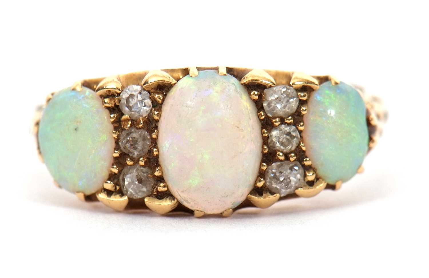 Lot 12 - An opal and diamond ring, the three slightly...