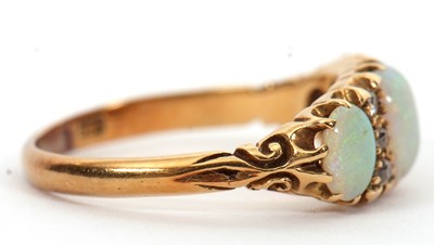 Lot 12 - An opal and diamond ring, the three slightly...