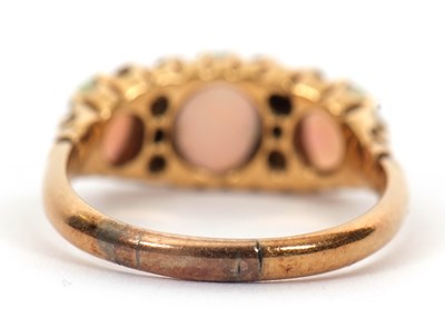 Lot 12 - An opal and diamond ring, the three slightly...