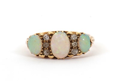 Lot 12 - An opal and diamond ring, the three slightly...