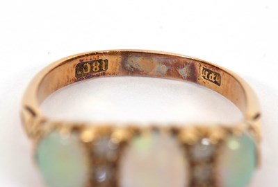 Lot 12 - An opal and diamond ring, the three slightly...