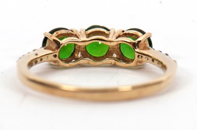 Lot 16 - A 9ct diopside and white stone ring, the three...